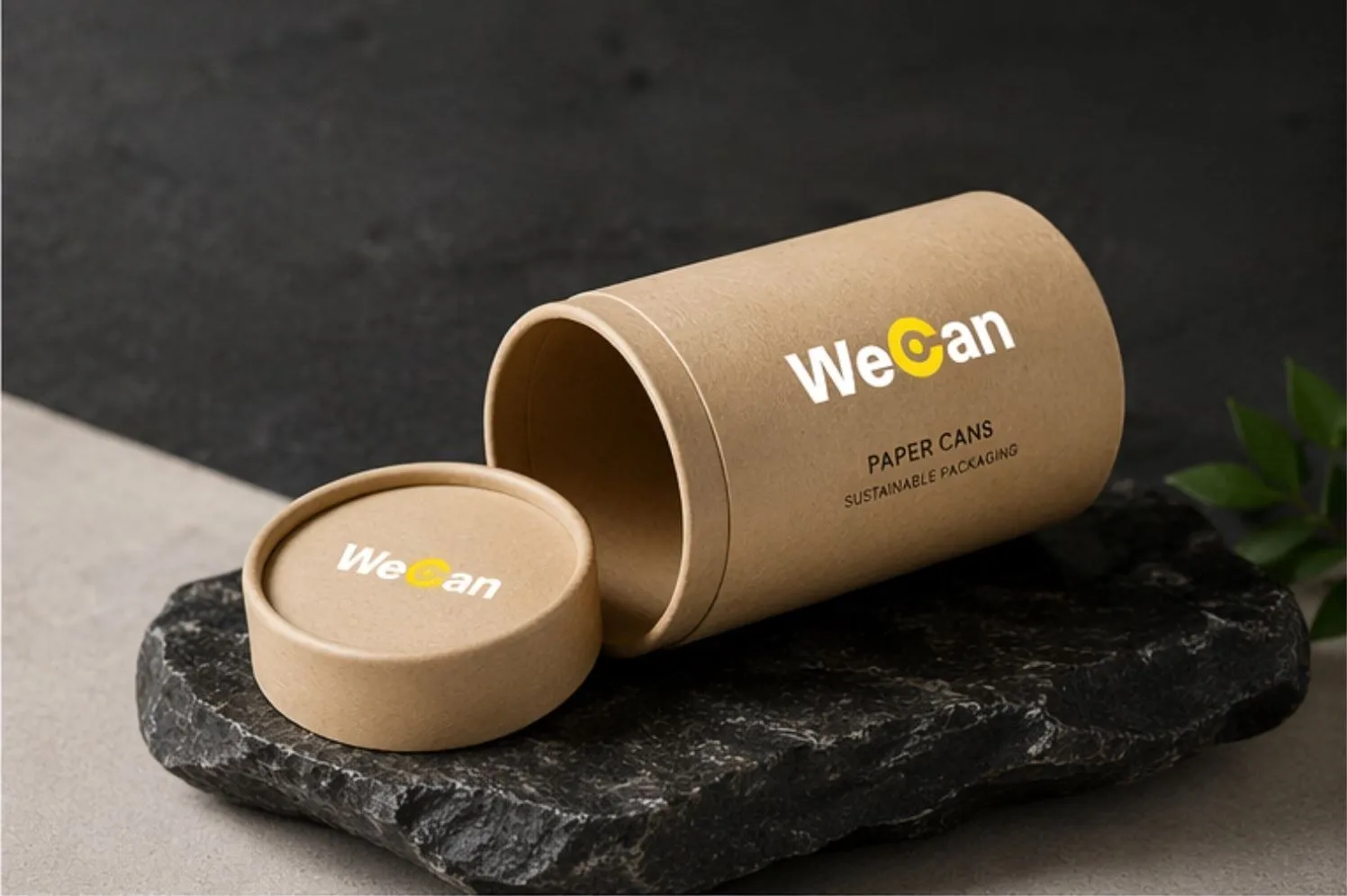 Kraft curling can with its lid off on a stone base